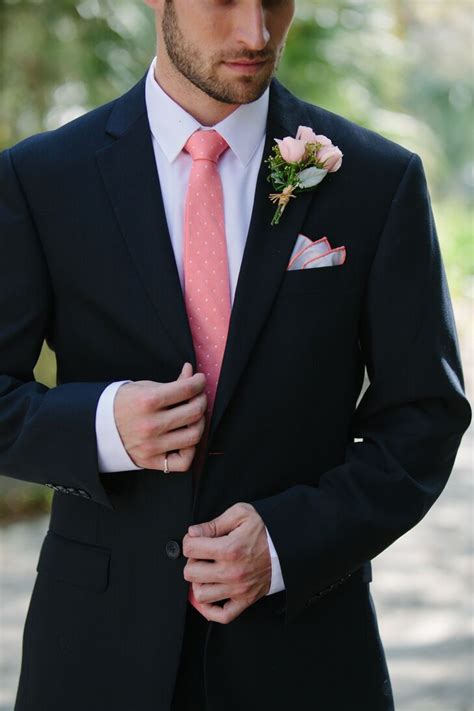 navy suit with pink tie.